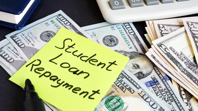 Money for Student Loan Repayment on a table. 