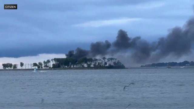 Smoke billows from the horizon near Hart Island. 